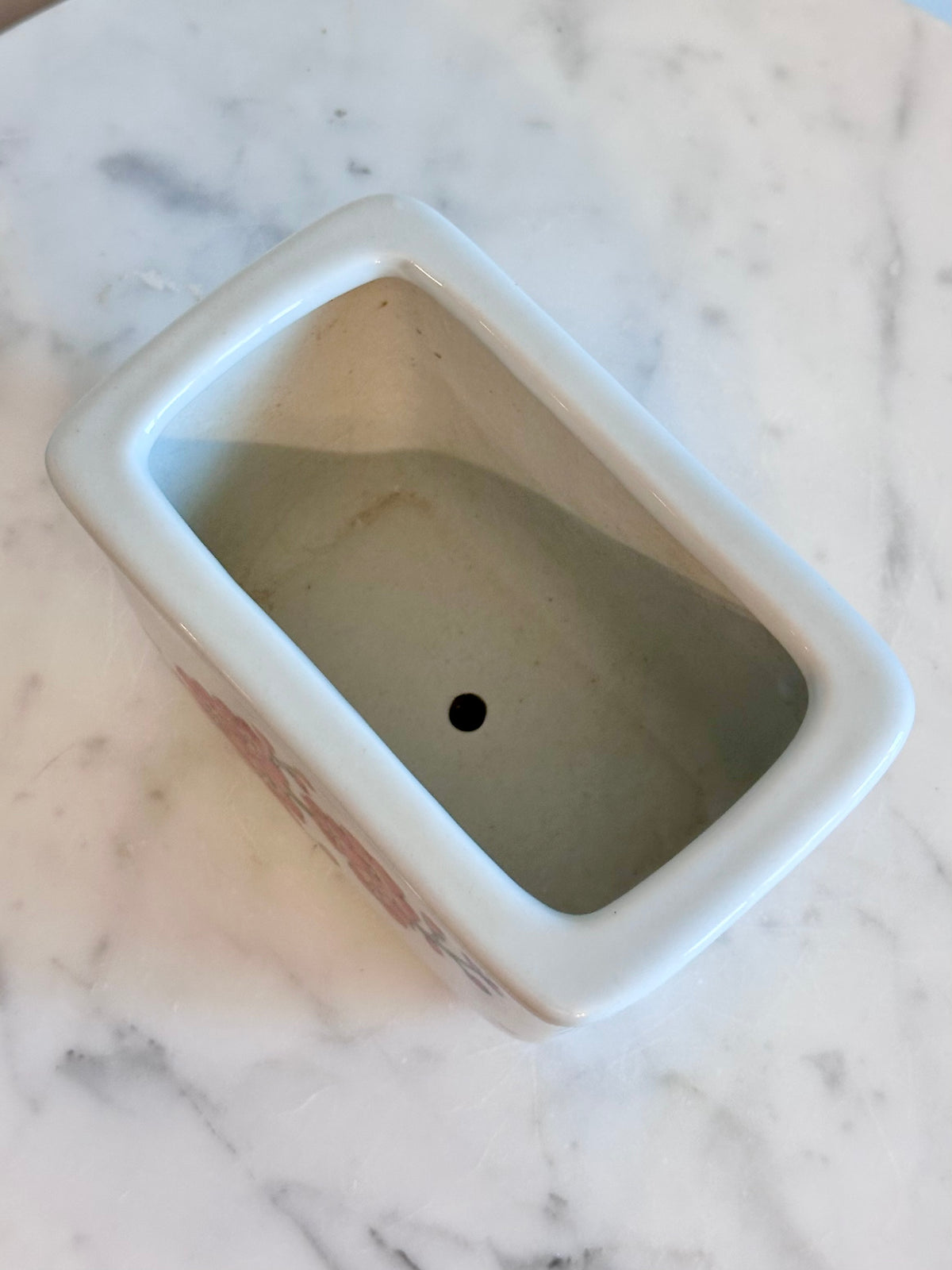 A square ceramic planter with rounded corners and a small drainage hole, shown from an overhead angle on a white marble surface., photo 4