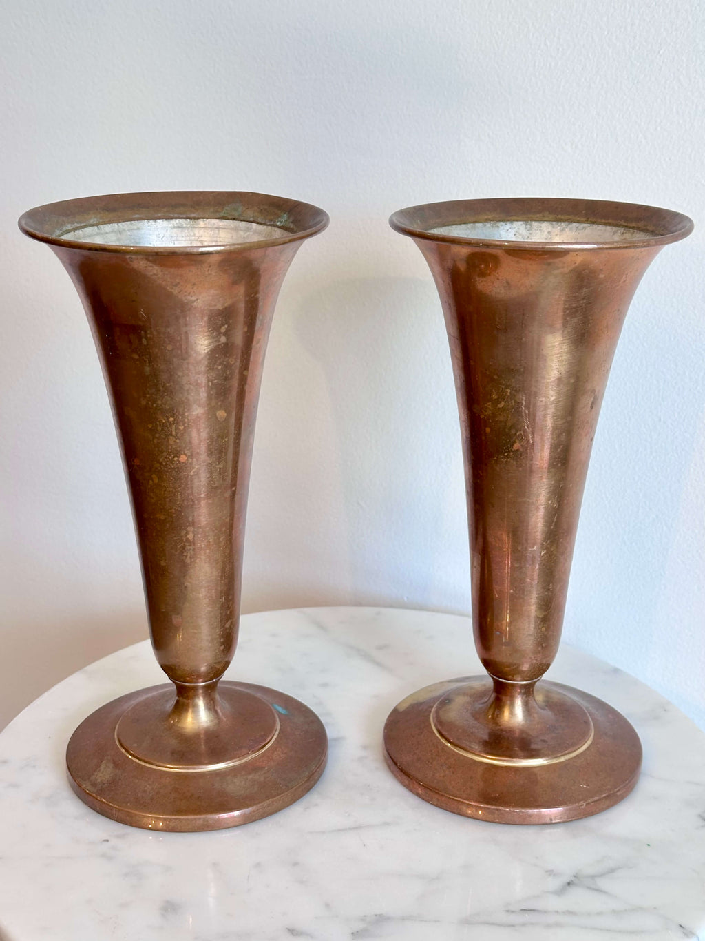 Pair of Vintage Brass Trumpet Style Church Altar Vases displayed on a white marble surface against a plain white wall.