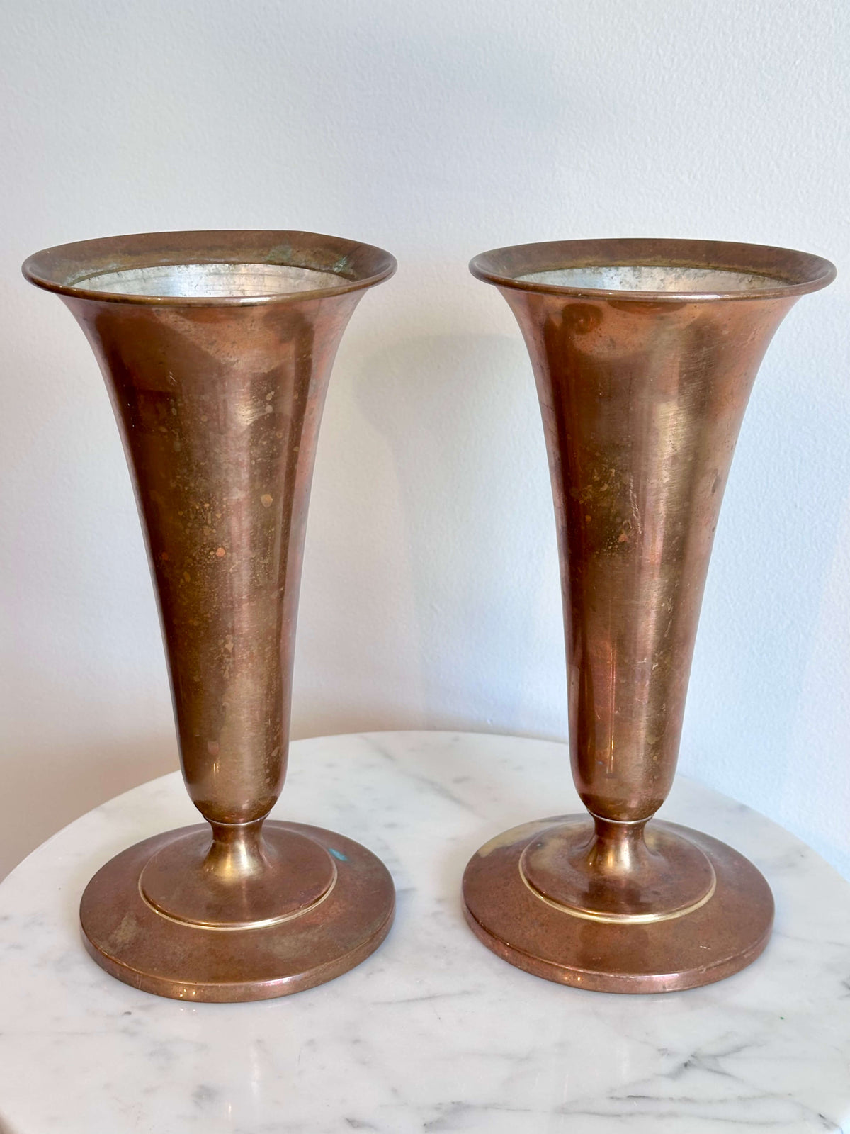 Pair of Vintage Brass Trumpet Style Church Altar Vases displayed on a white marble surface against a plain white wall.