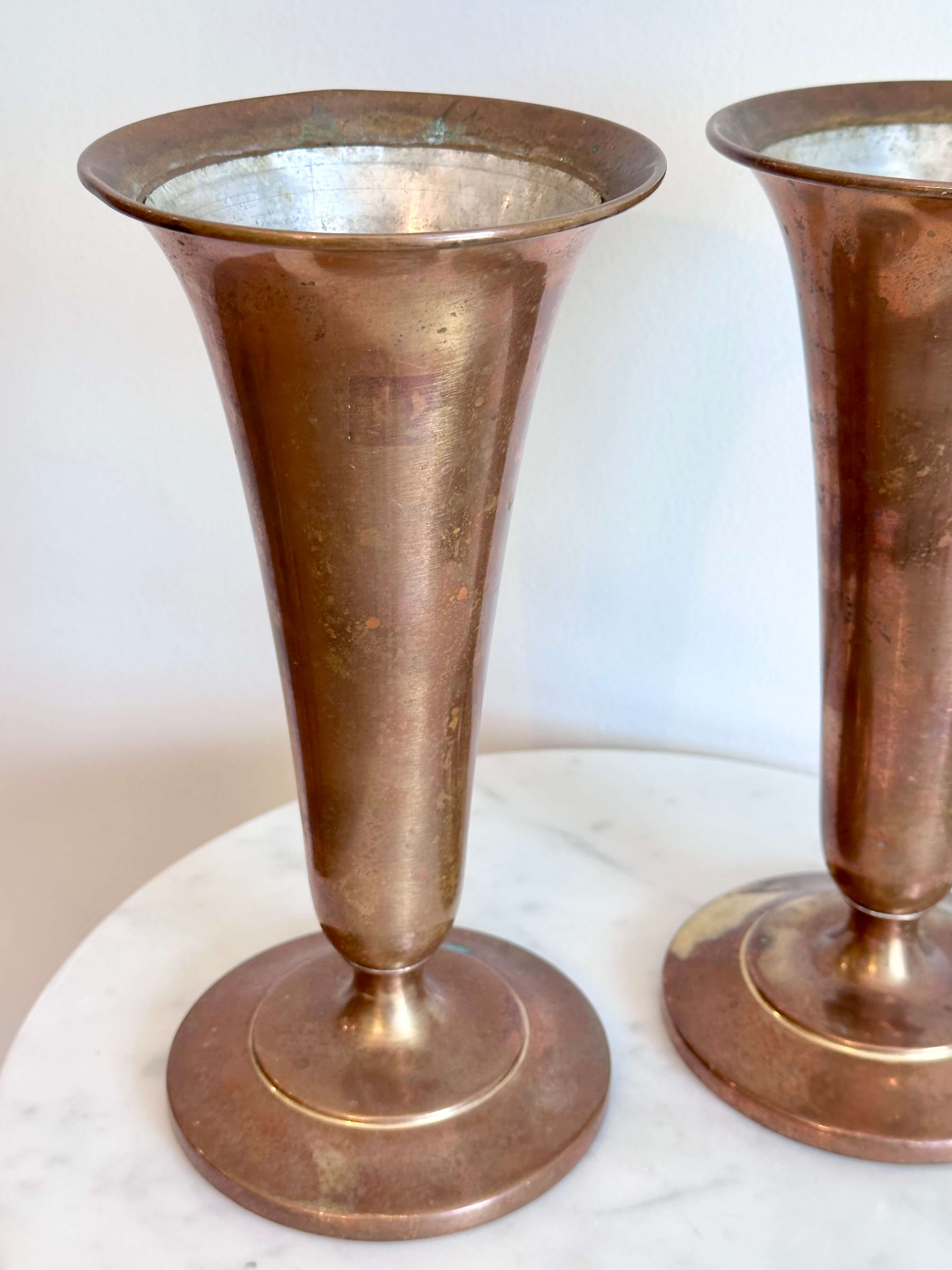 Pair of Vintage Brass Trumpet Style Church Altar Vases displayed on a white marble surface against a plain white wall.