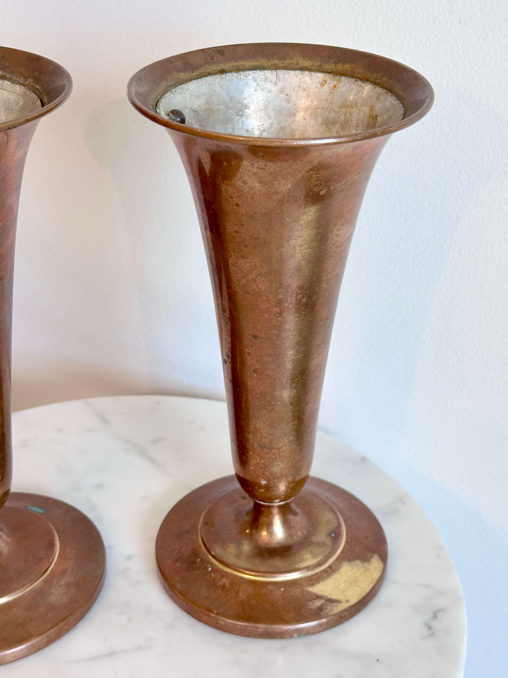 Pair of Vintage Brass Trumpet Style Church Altar Vases displayed on a white marble surface against a plain white wall.