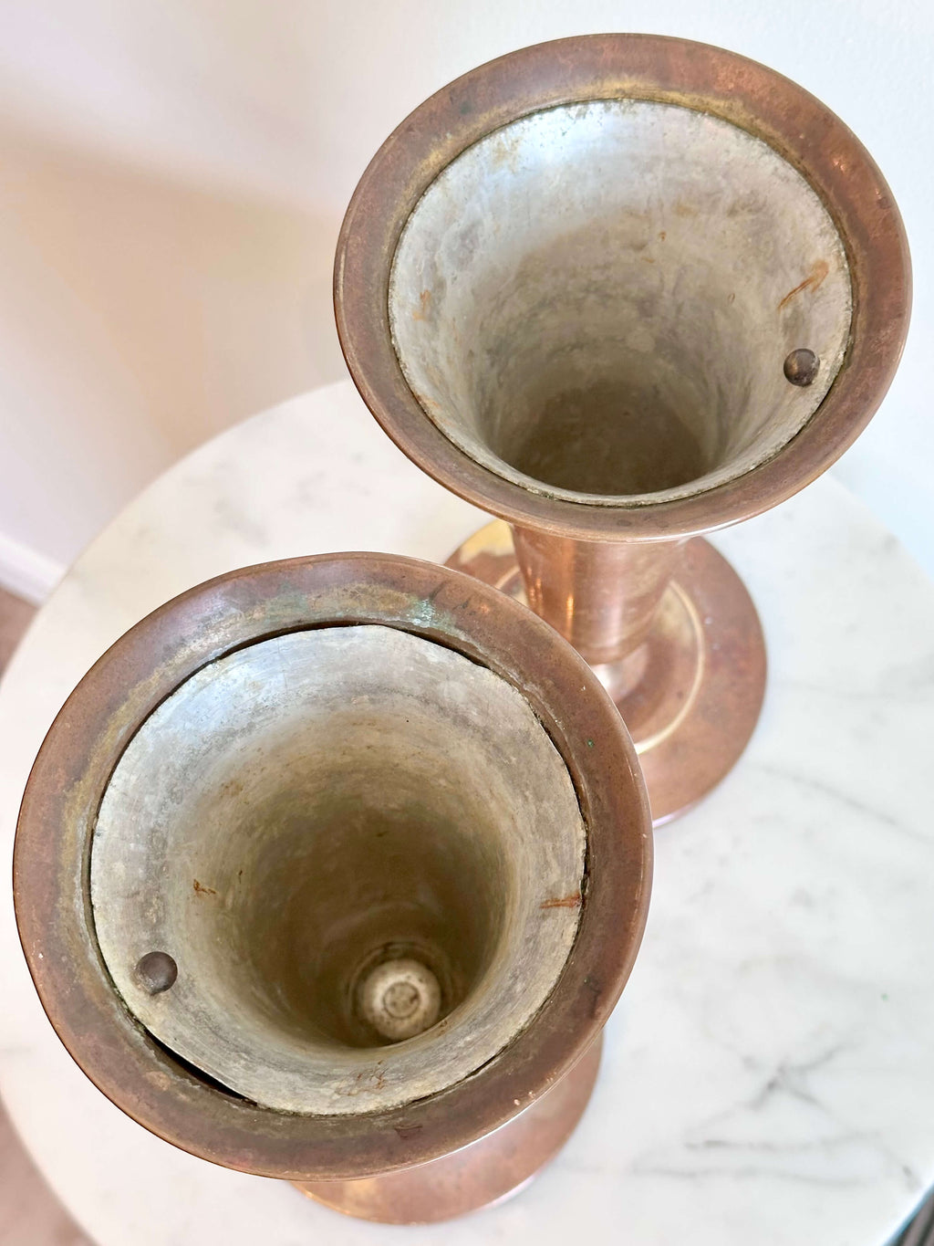 Top View of Vintage Brass Trumpet Style Church Altar Vase displayed on a white marble surface against a plain white wall.