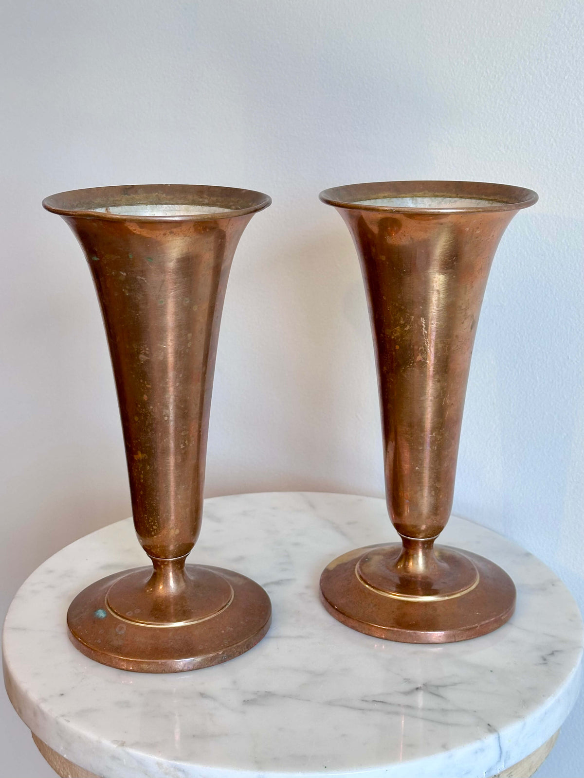 Pair of Vintage Brass Trumpet Style Church Altar Vases displayed on a white marble surface against a plain white wall.